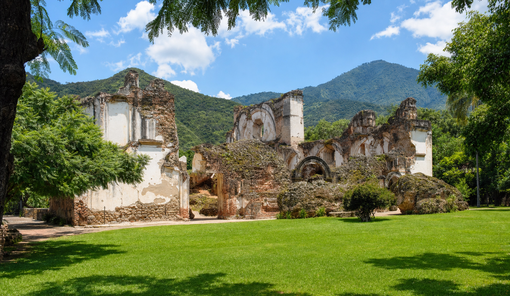 La Recoleccion colonial ruins with green lawn and volcanic mountains behind